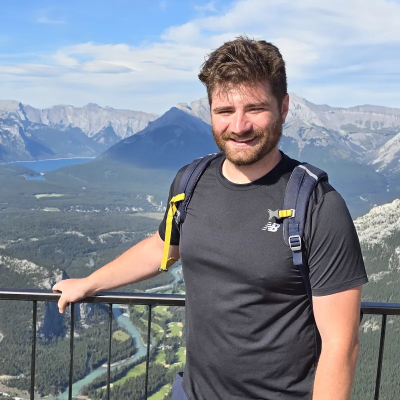 Oscar ONeill standing at a mountain overlook in Banff, Alberta.